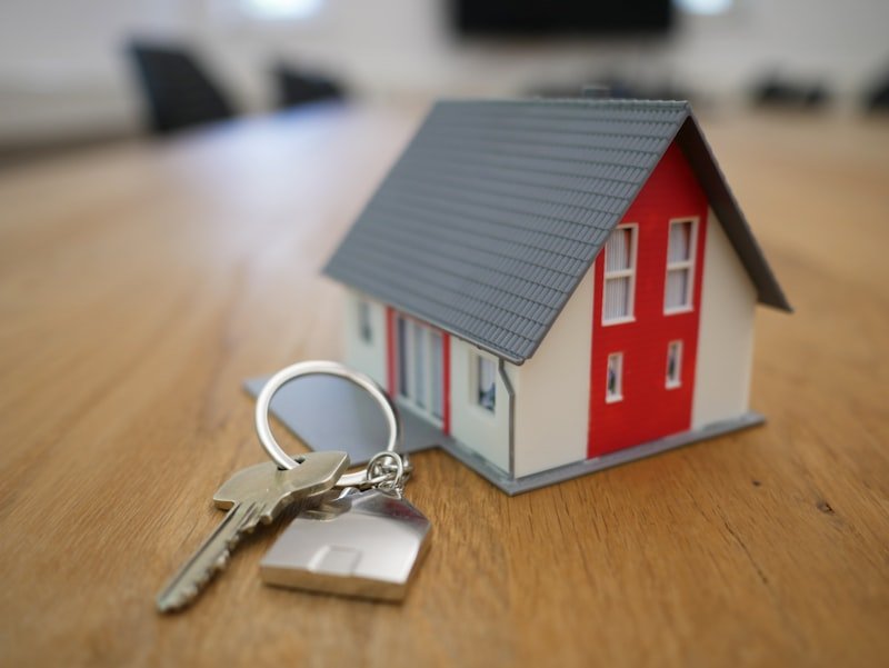 Couple reviewing home purchase documents with keys