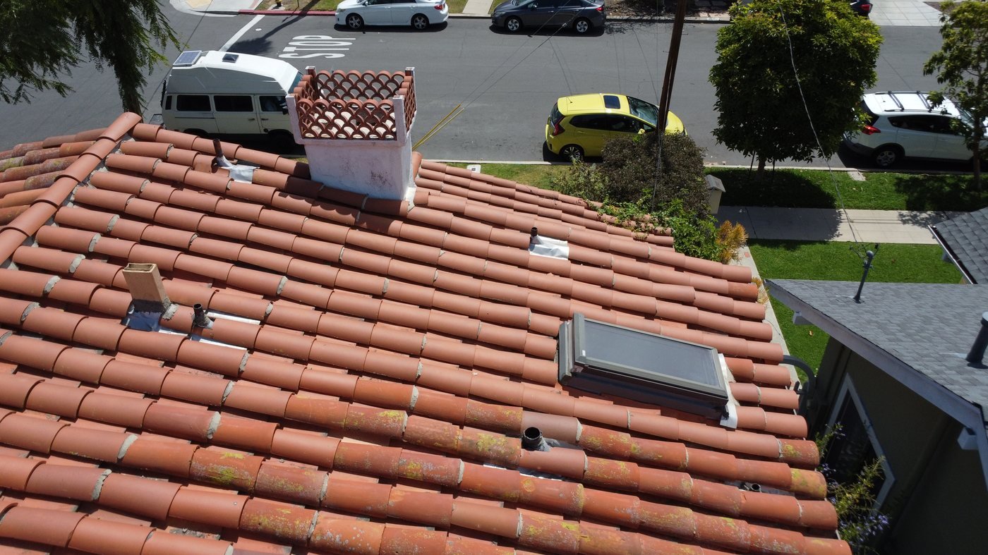 Aerial view of a clay tile roof with skylight and chimney in San Diego