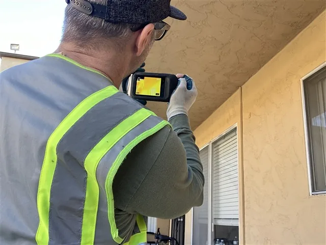 Inspection photo: inspector infrared wall scan